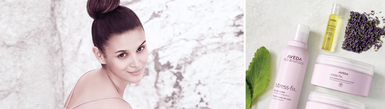 Aveda stress-fix products on white marble with a sage leaf