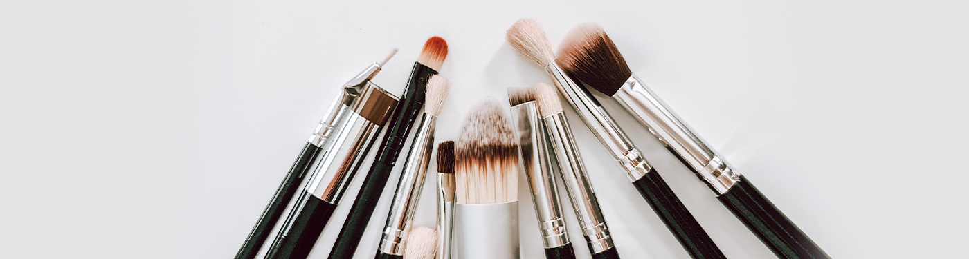 A fan of makeup brushes on white